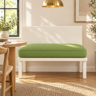 Custom green banquette bench cushion on a white kitchen banquette next to a dining table
