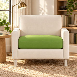 Custom green single seat couch cushion on a cream armchair