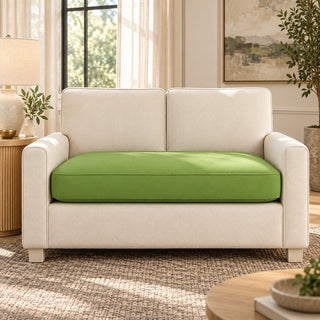 Custom green couch cushion on a cream loveseat in a living room